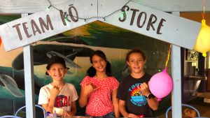 3 learners standing in their Team Ko Store.