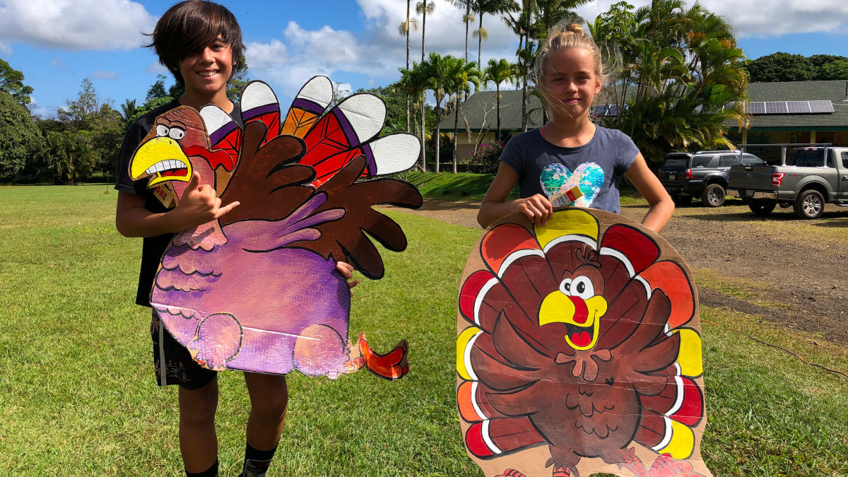 learners holding cardboard turkeys