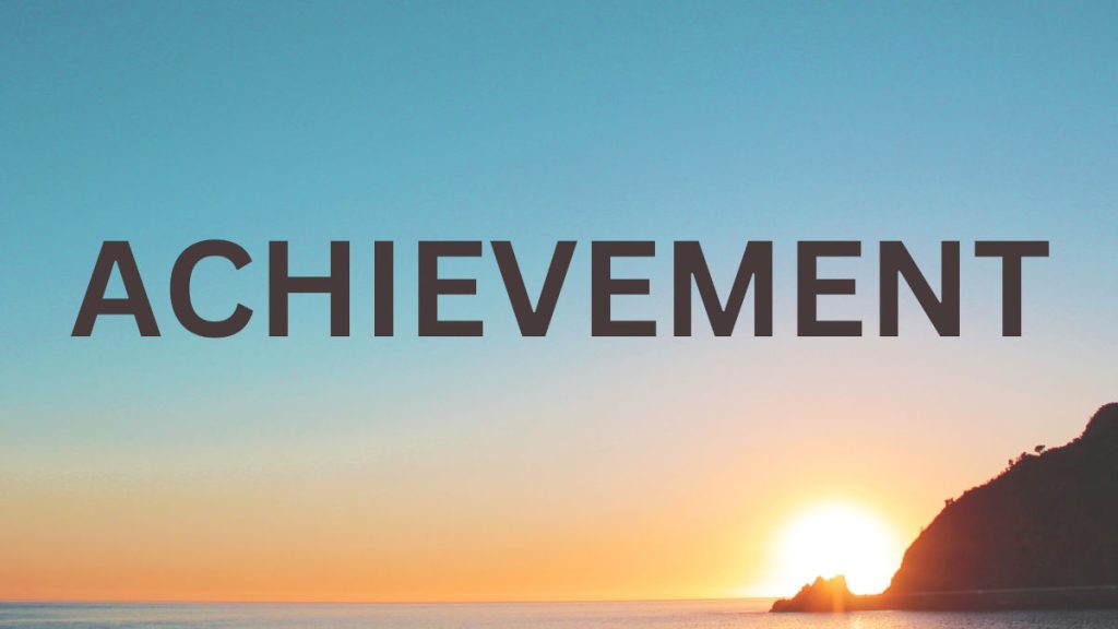 "Achievement" text over a background of a sunset
