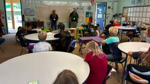 AOK learners listening to a presentation in a classroom