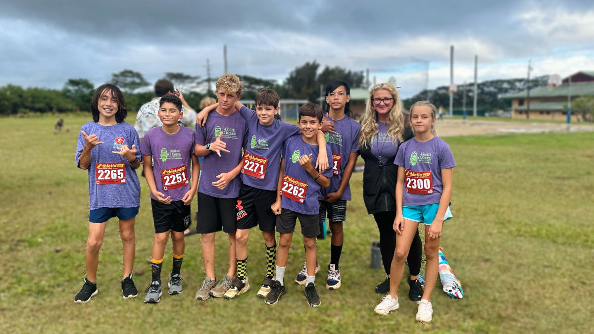 Image of AOK Middle School Cross Country Team standing in green field